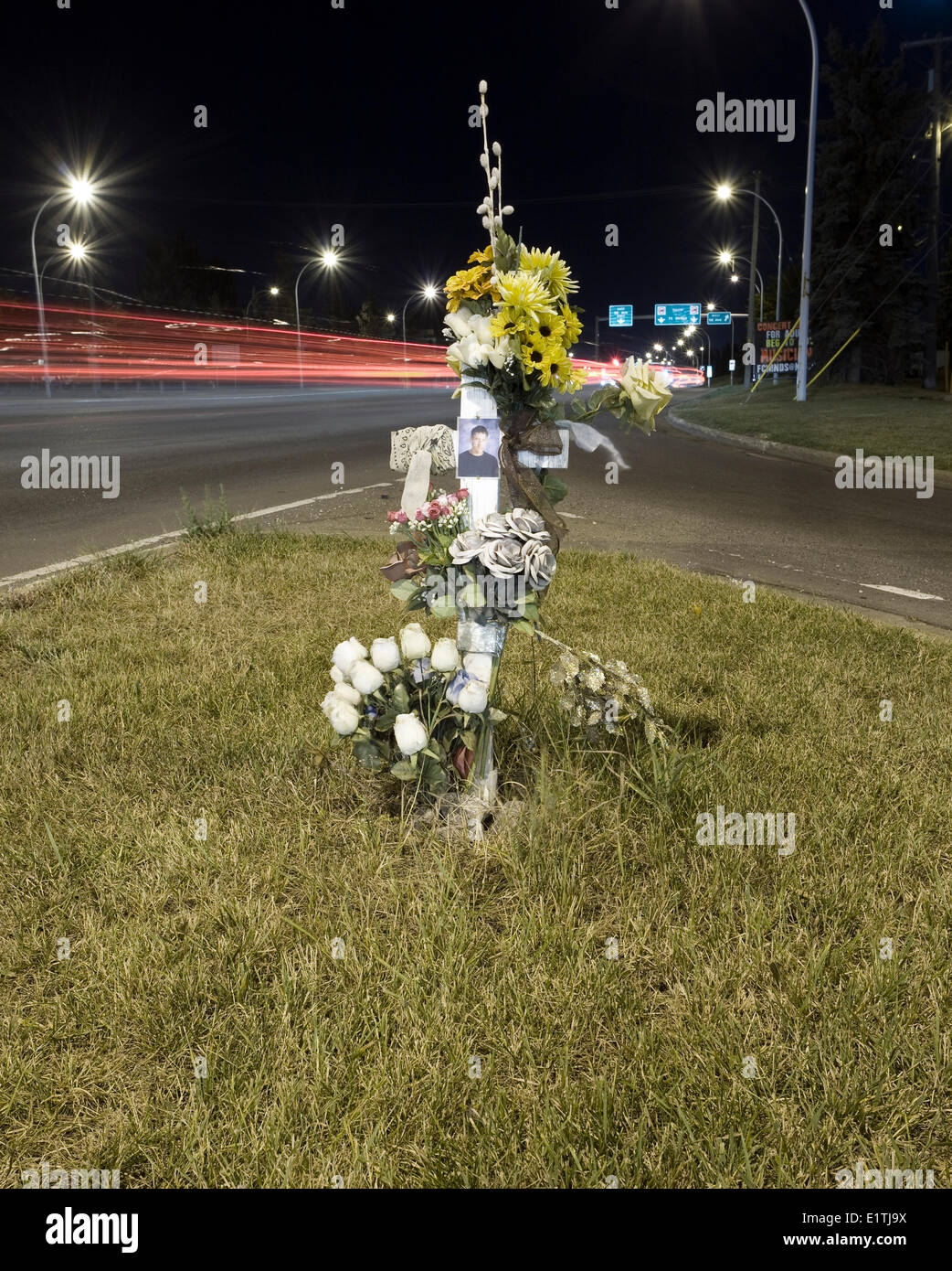 Road side cross at urban intersection memorial for traffic death. Stock Photo