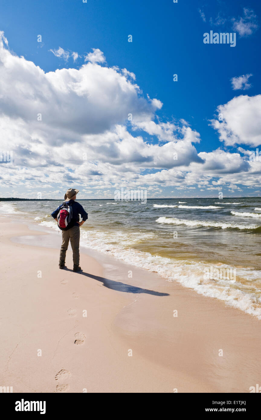 hiker along Big Buffalo Beach, Peter Pond Lake, Buffalo Narrows