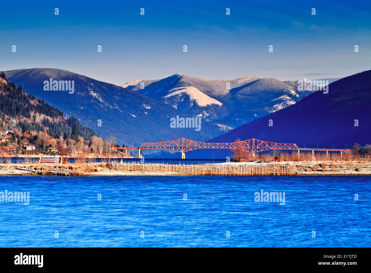 A sunny early winter day on the waterfront in Nelson, BC with the Big Orange Bridge in the background. Stock Photo