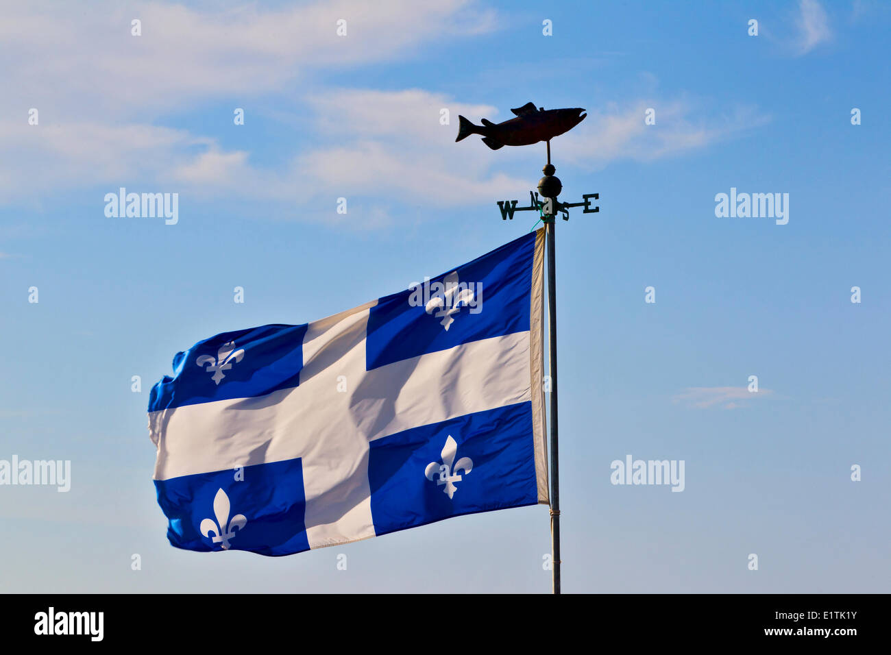 Salmon windvane and Quebec flag, Carleton-sur-Mer, Gaspe, Quebec, Canada Stock Photo
