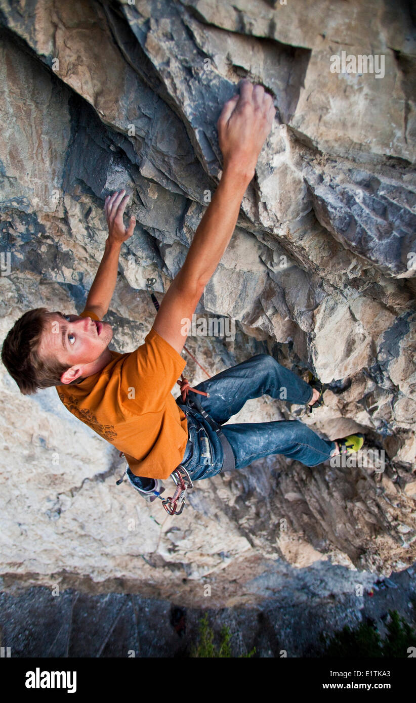 A man sport climbing at sunset on Grotto Mountain. Standard Deviation 11b, Echo Canyon, Canmore, Alberta, Canada Stock Photo