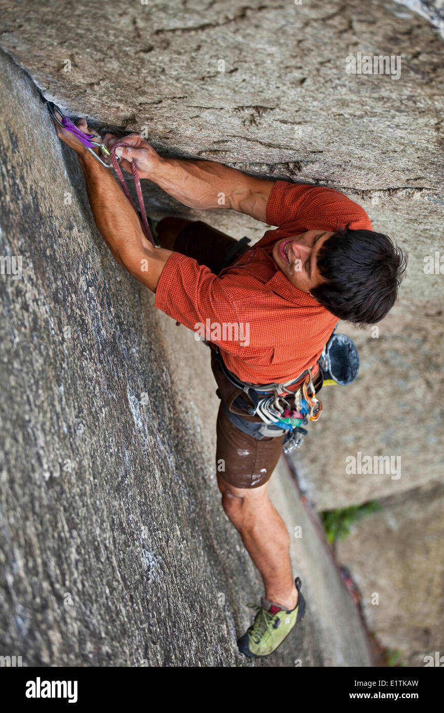 A strong male climber climbs a corner crack, Caboose 10b, Squamish, BC Stock Photo