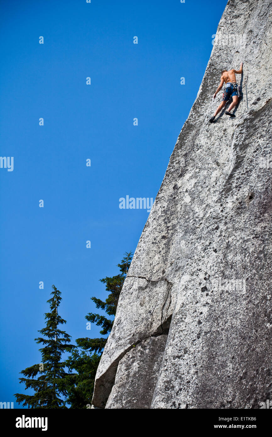 A strong male climber climbing Crescent Crack 10d, Squamish, BC Stock Photo