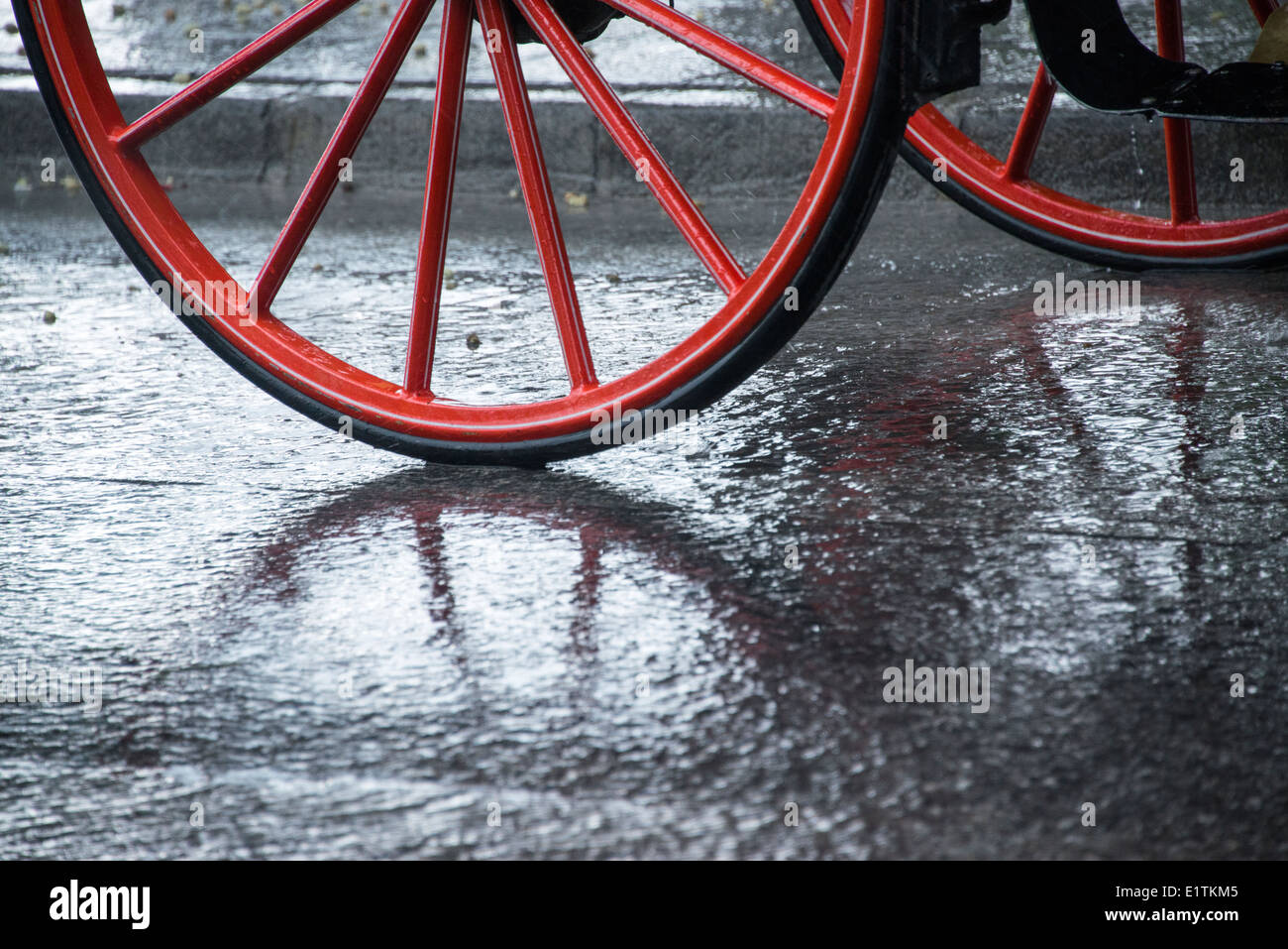 Red wheels in the rain Stock Photo