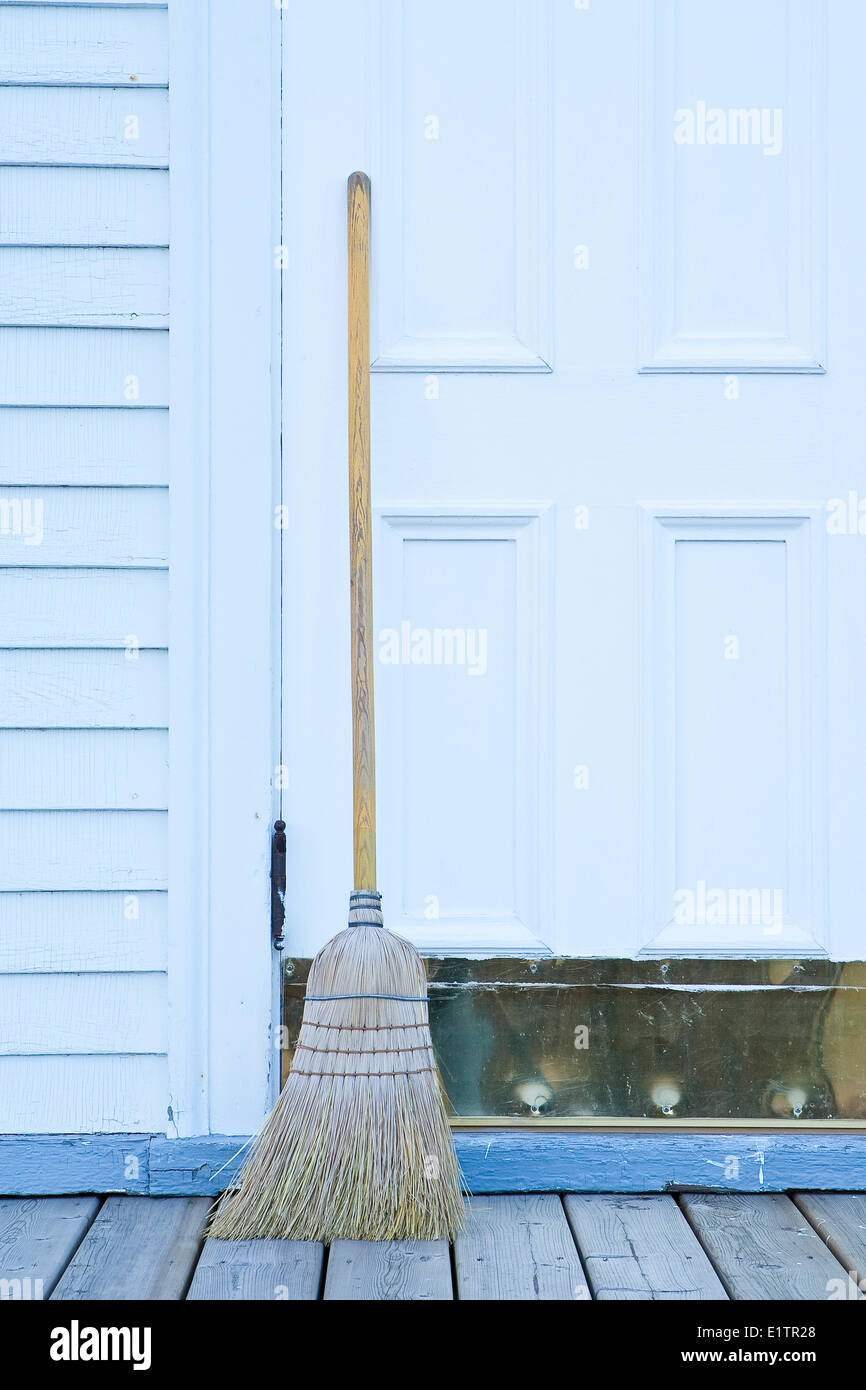 Broom propped up by rural Church door, Alberta, Canada Stock Photo