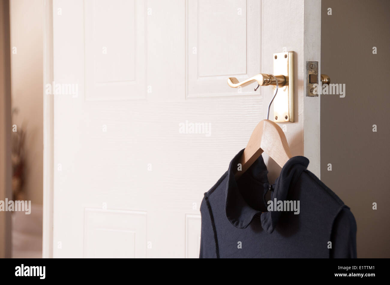Dress hanging on bedroom door handle Stock Photo Alamy