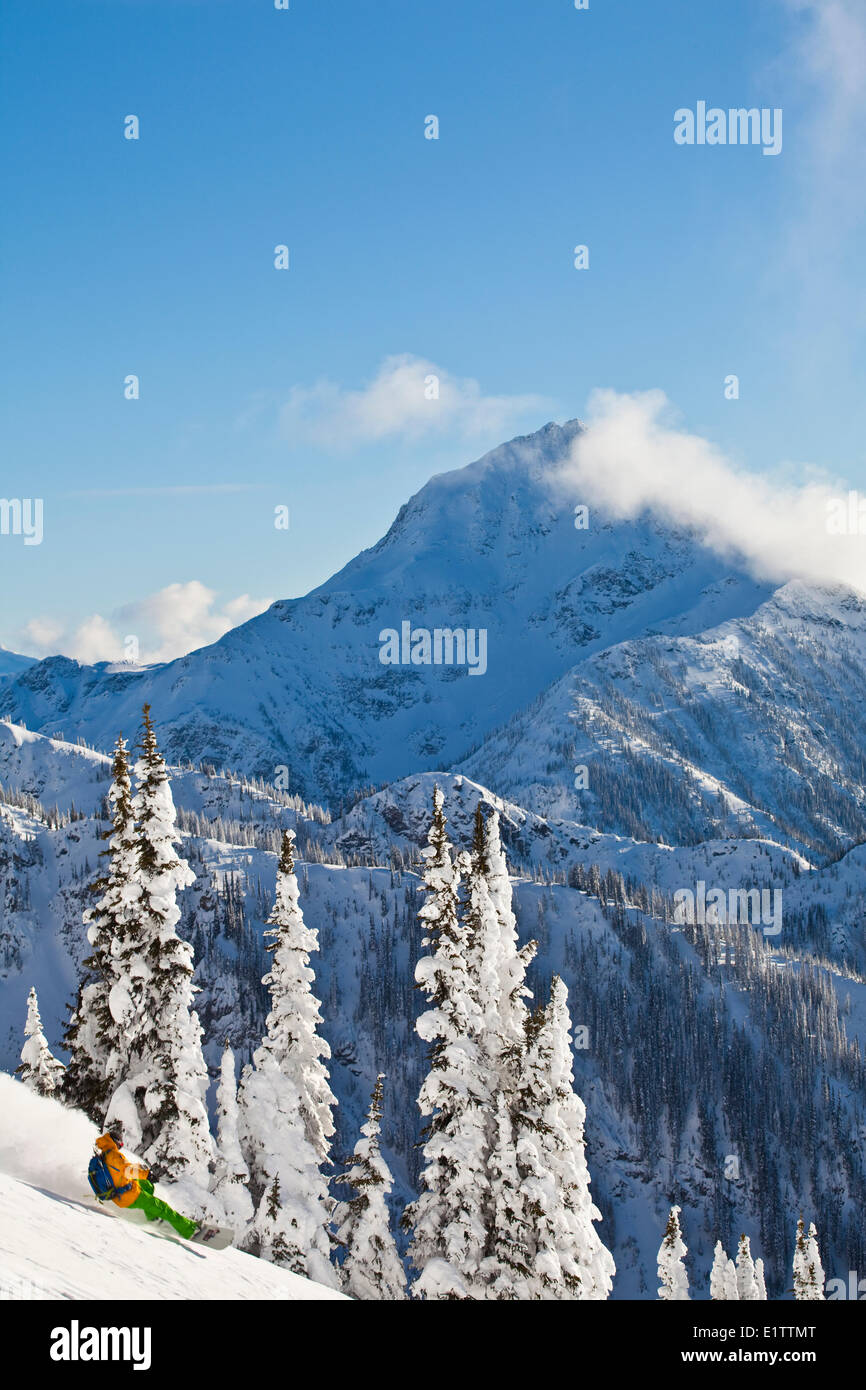 A male backcountry snowboarder at Revelstoke Mountain Resort, Revelstoke, BC Stock Photo