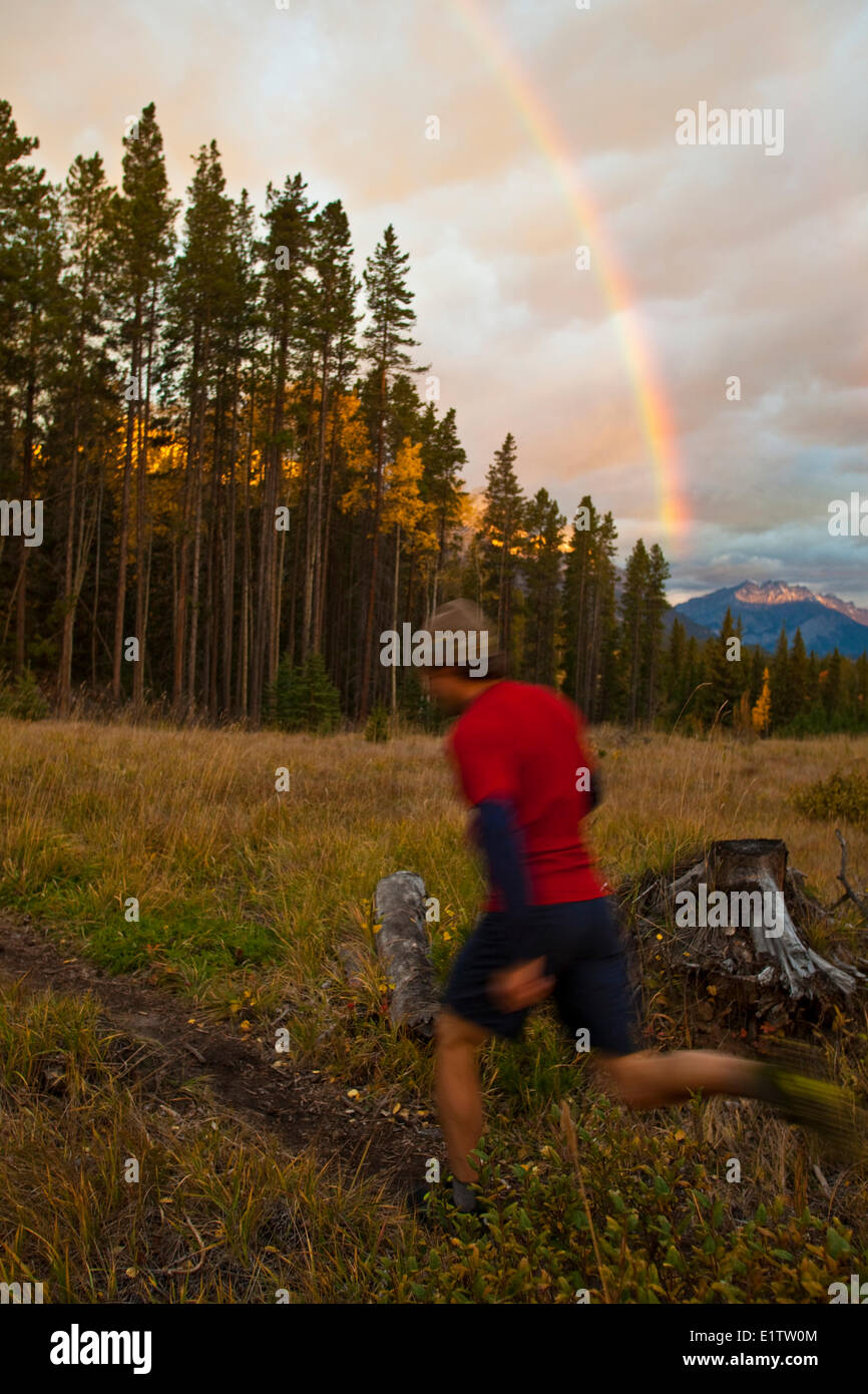 A young, fit woman trail running the Highline trail in Canmore, AB