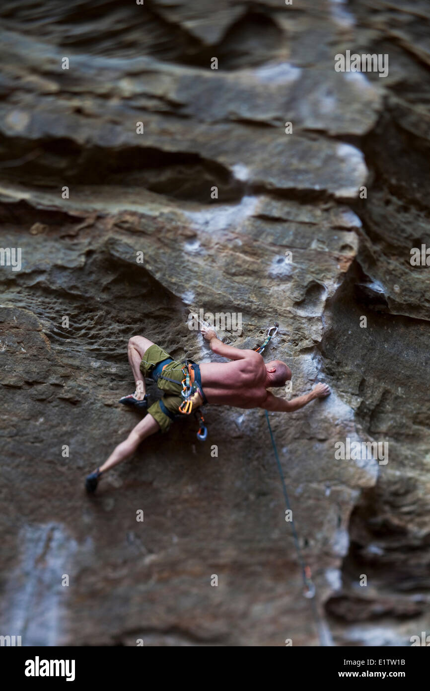 A strong male climber sport climbing RoShampo 12a, Red River