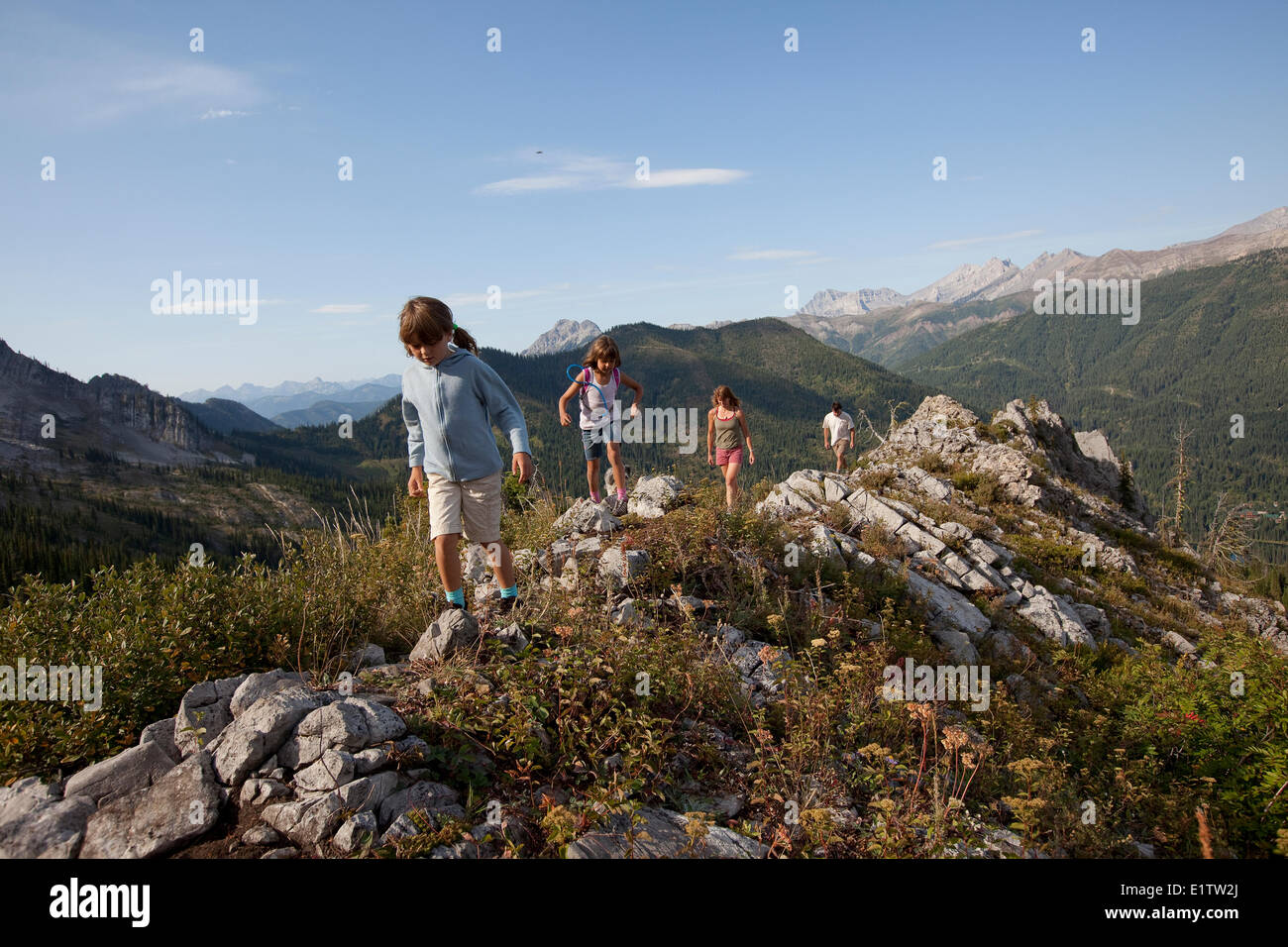 Young family hikes on Spineback Trail in Lizard Range, Fernie, BC, Canada. Stock Photo