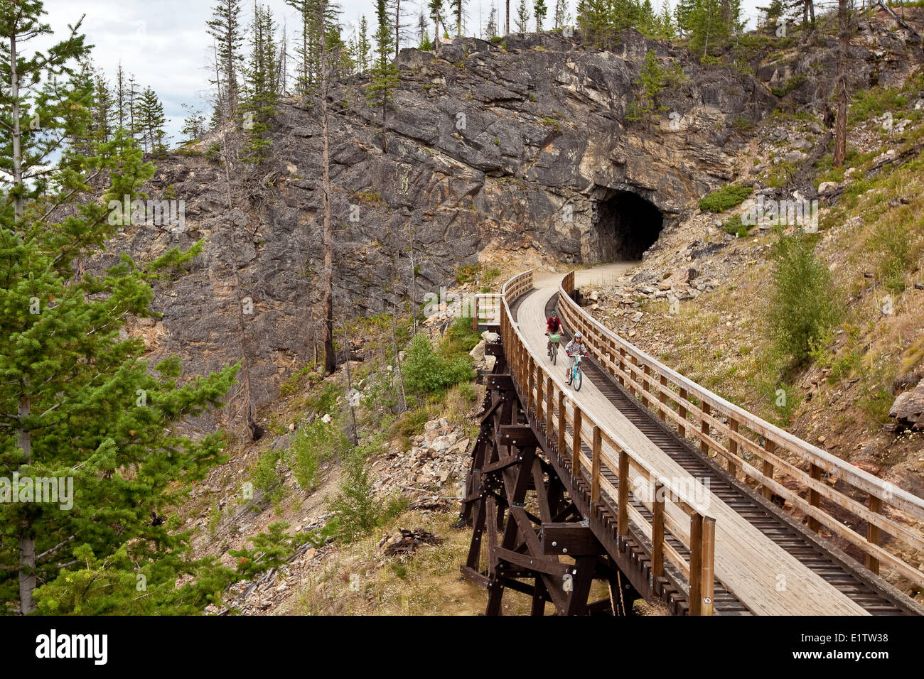 Young family cycling the Kettle Valley Railway Trail through Myra