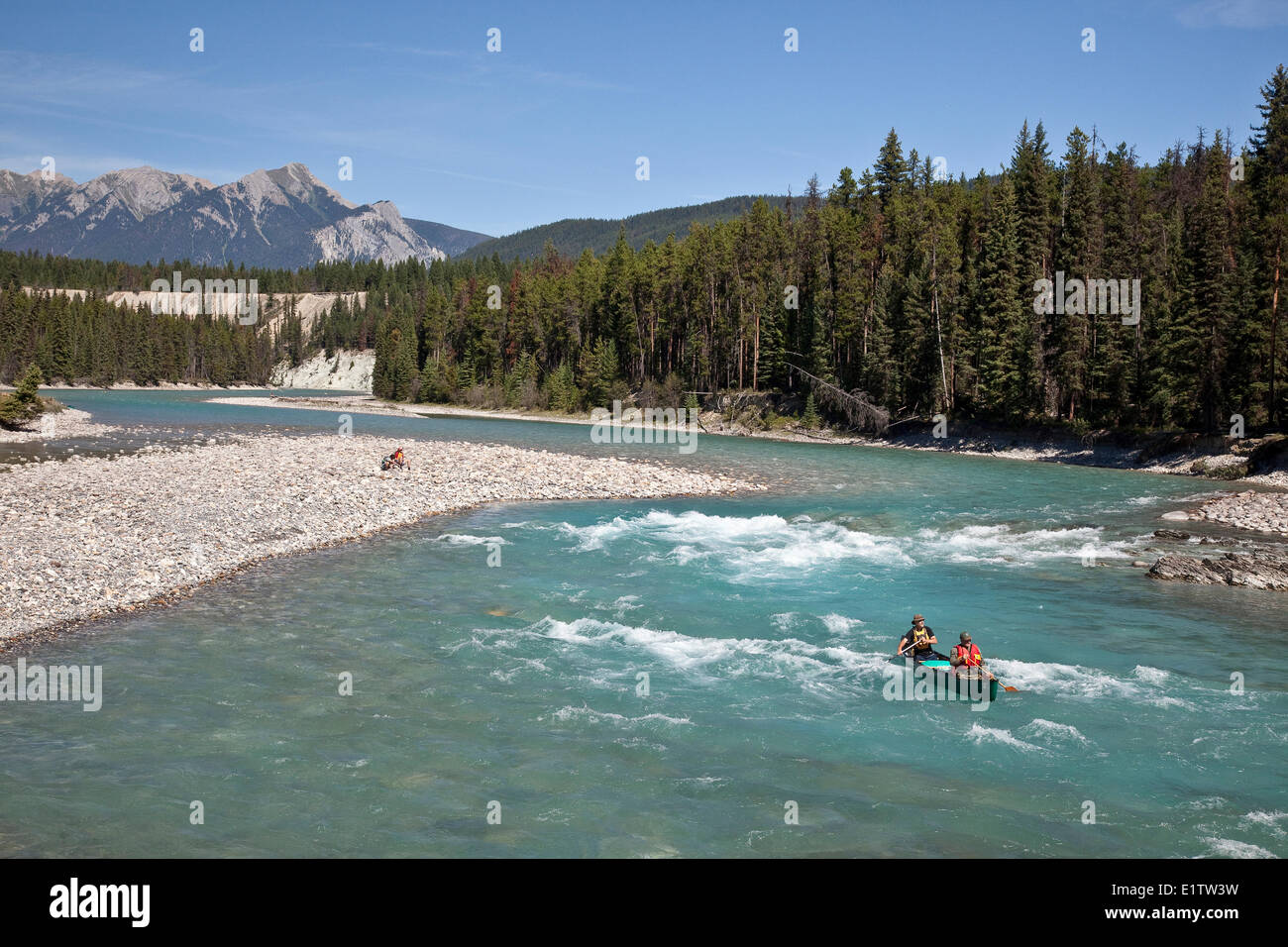 Two men paddle canoe on Kootenay River, Kootenay National Park, BC