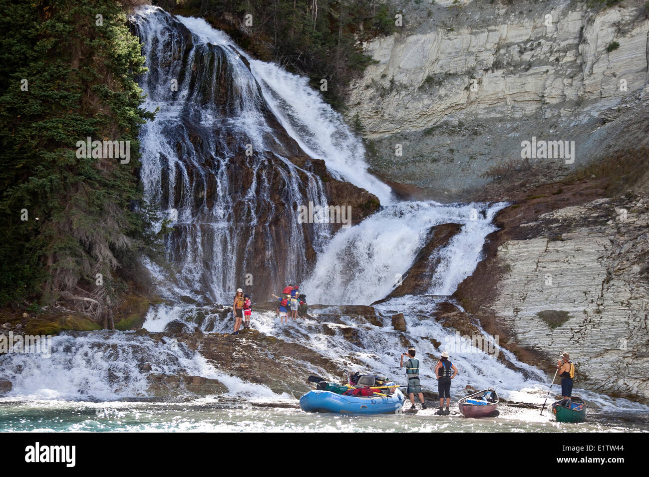 Several families enjoy river trip in canoes and one raft on Kootenay River, Kootenay National Park, BC, Canada. Stock Photo