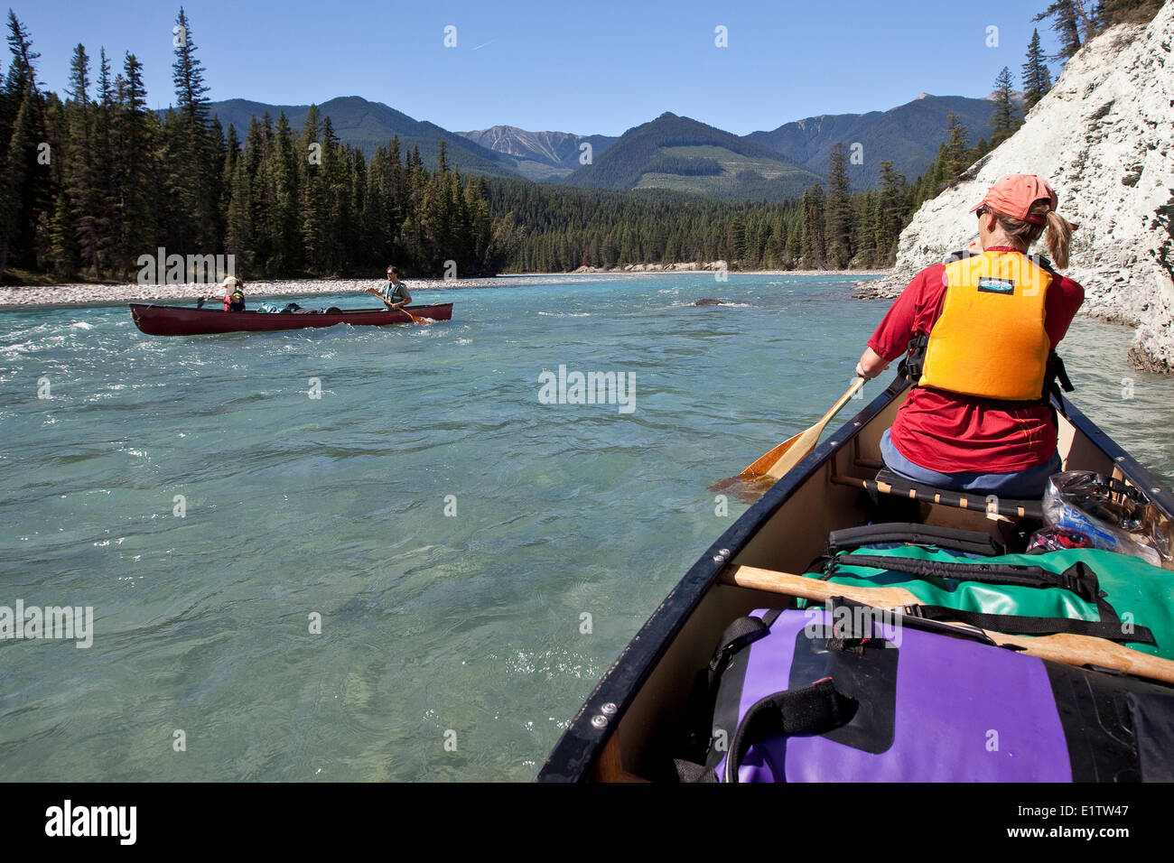Several families enjoy river trip in canoes and one raft on Kootenay River, Kootenay National Park, BC, Canada. Stock Photo