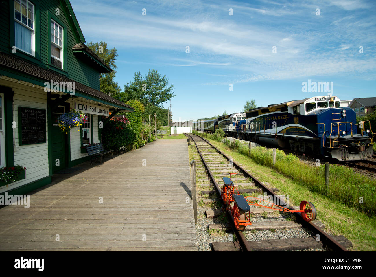The Rocky Mountaineer passes the Fort Langley train station museum. Fort Langley, BC, Canada Stock Photo
