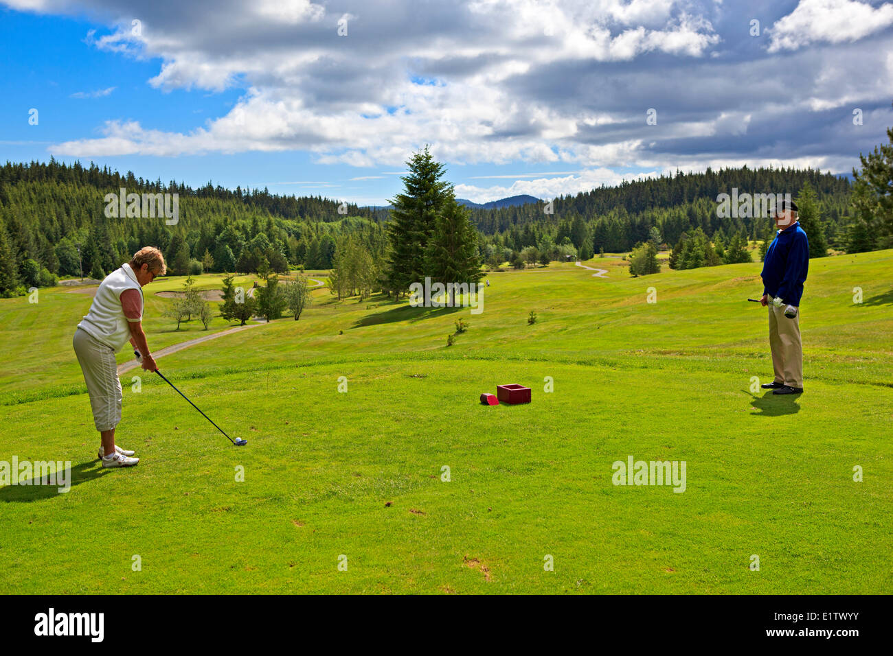 Retired senior couple enjoying a round of golf at the Seven Hills Golf & Country Club on Northern vancouver Island, British Colu Stock Photo