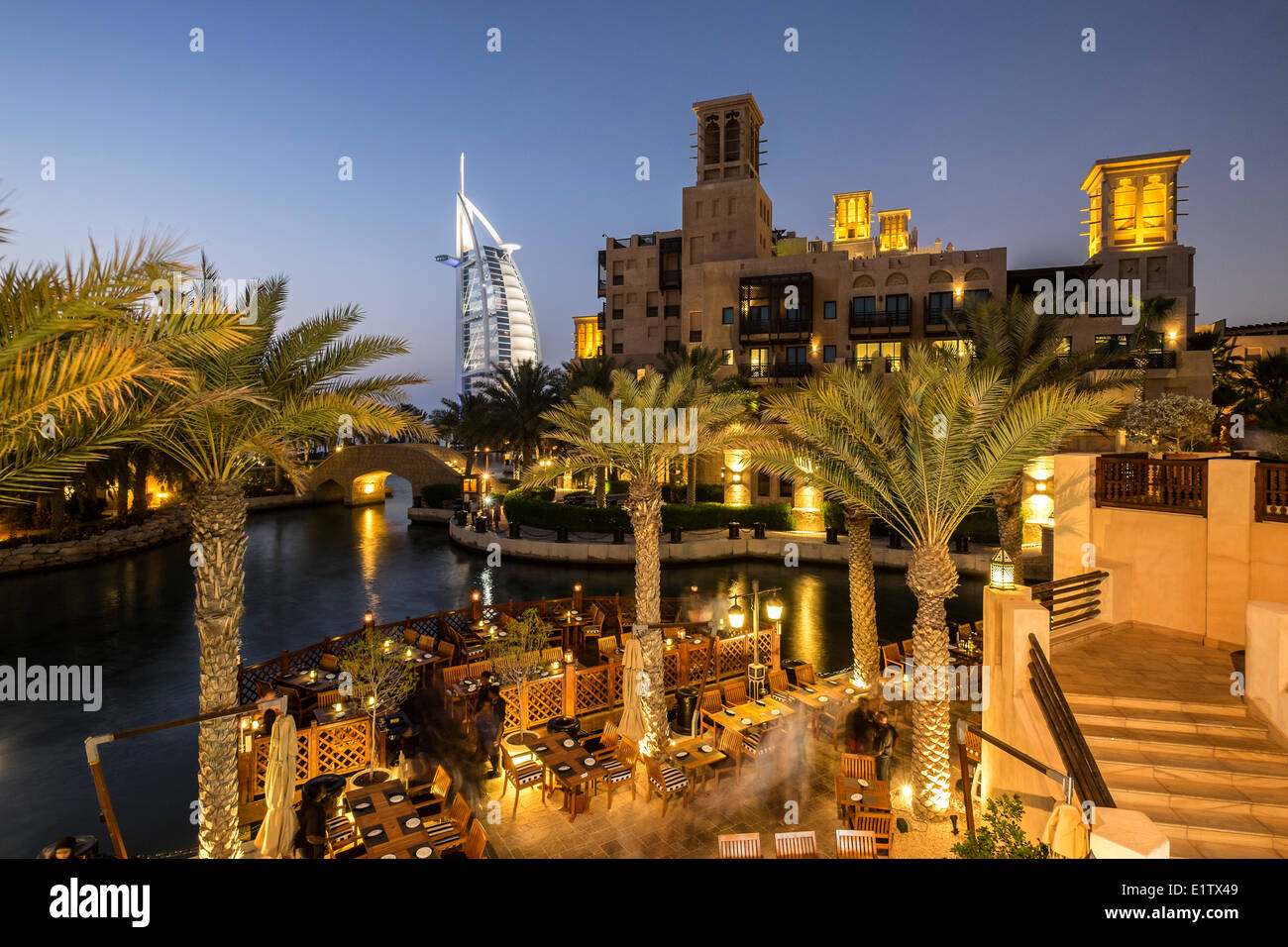 Evening view of Madinat Jumeirah entertainment quarter and Burj al Arab Hotel in Dubai United Arab Emirates Stock Photo