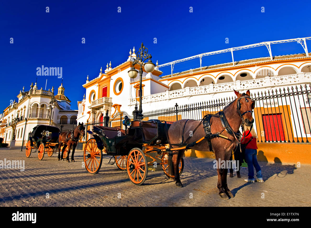 Horse drawn carriages outside the Plaza de Toros de la Maestranza (also La Real Maestranza - Bullring) in the El Arenal Stock Photo