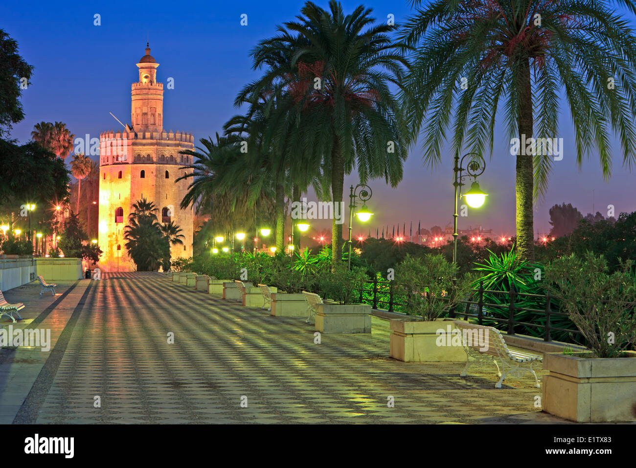 Torre del Oro (Tower of Gold) which also houses the Museo Maritimo along Paseo Alcalde Marques del Contadero at dusk Stock Photo