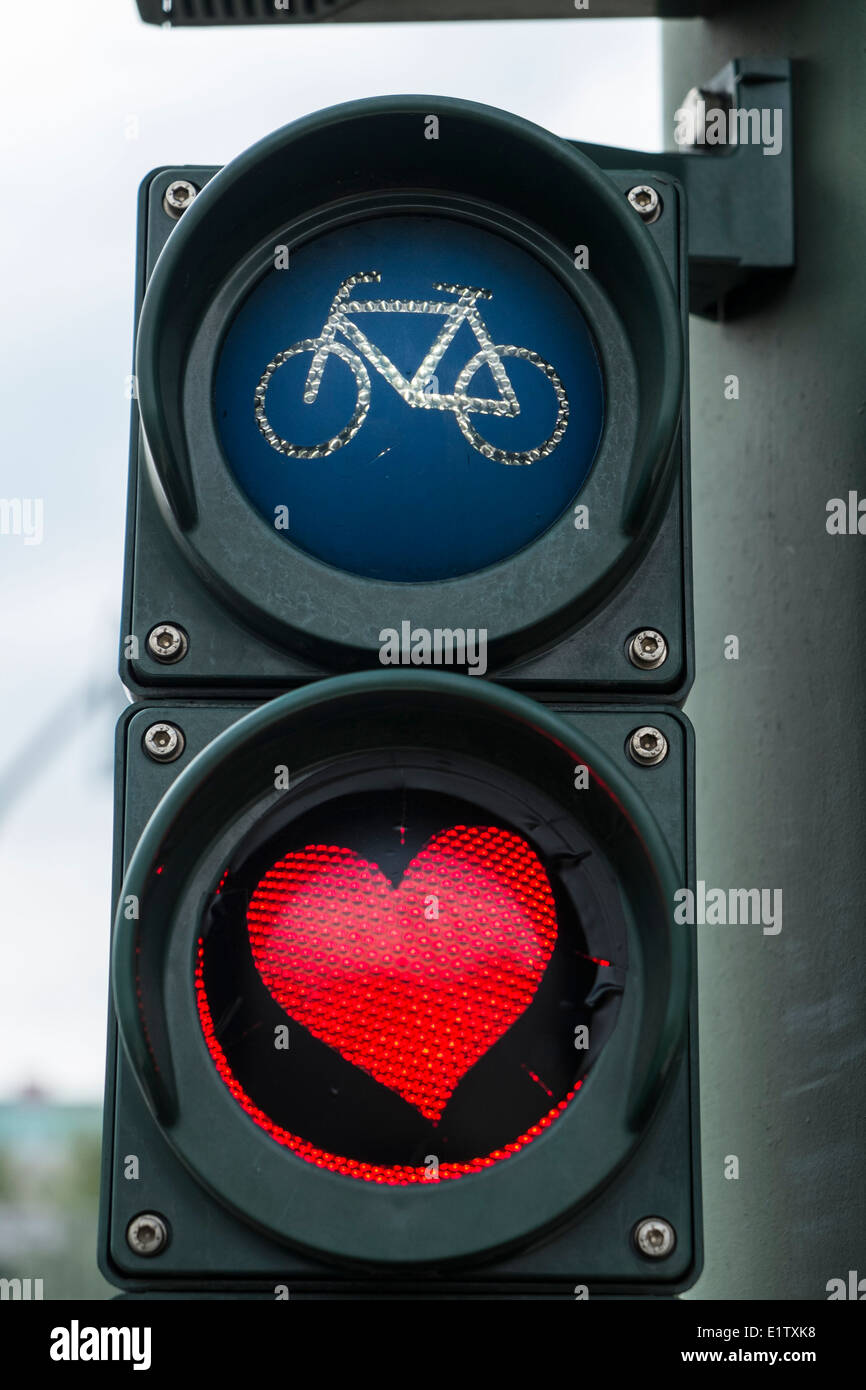 Red heart painted on stop light for bicycles in Berlin Germany Stock Photo