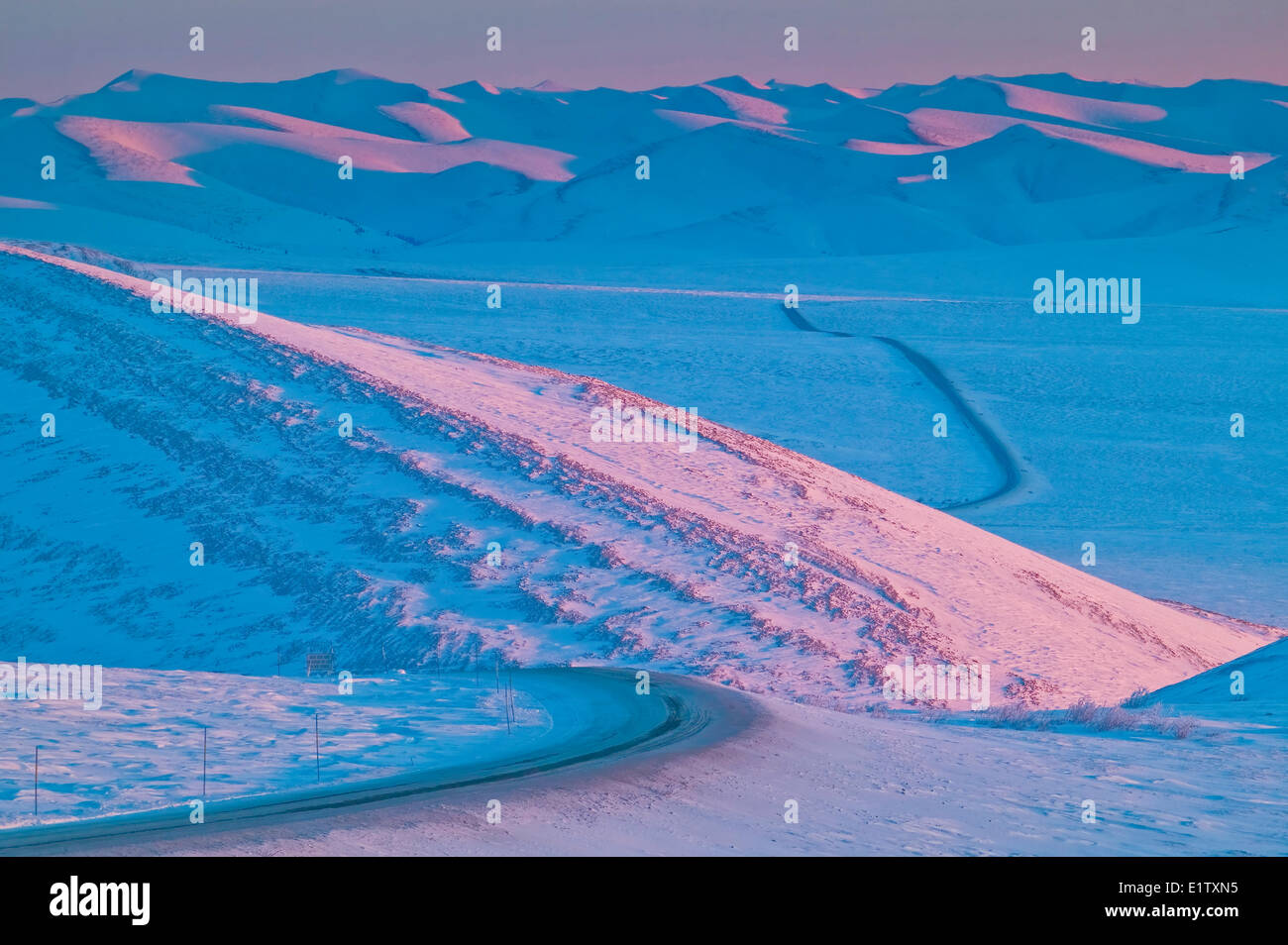 View down the Dempster Highway leading towards the Richardson Mountains in winter, Yukon Territory, Canada Stock Photo
