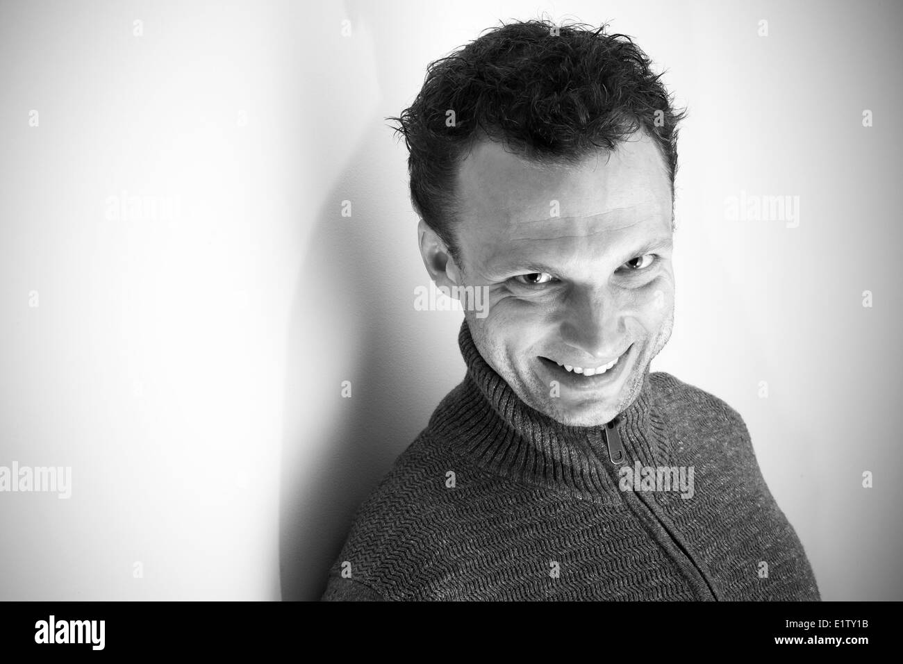 Angry laughing young Caucasian man monochrome portrait Stock Photo