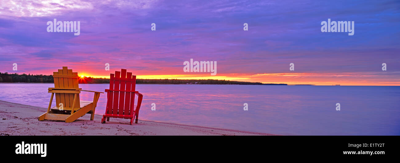 Adirondack Chairs at sunset, Manitoulin Island, Bayfield Sound on Lake Huron, Ontario, Canada Stock Photo