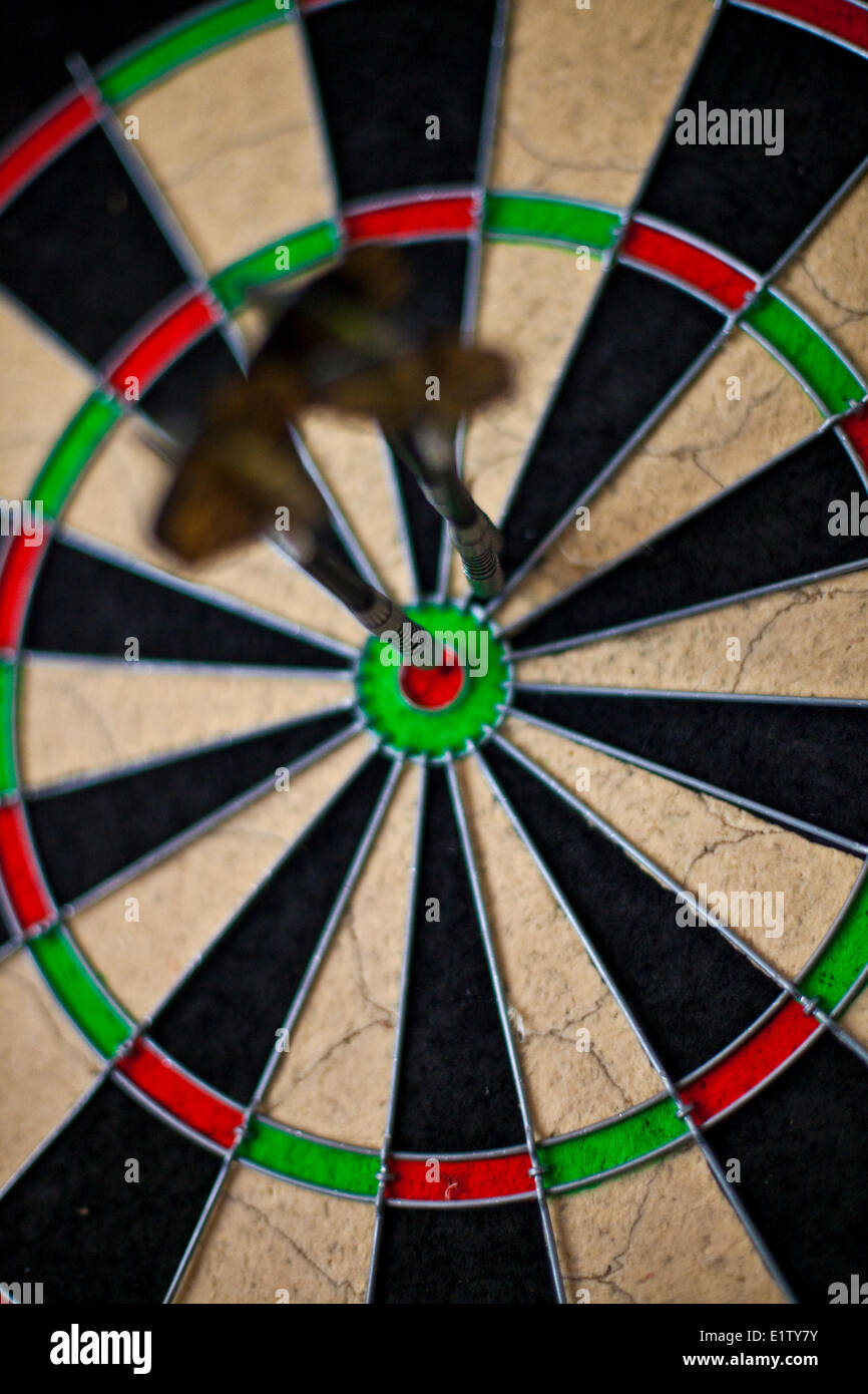 playing darts while backcountry skiing at a lodge. Revelstoke, BC Stock Photo