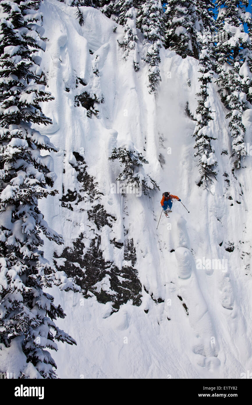 A male freeskier drops a huge cliff at Revelstoke Mtn Resort, BC Stock Photo