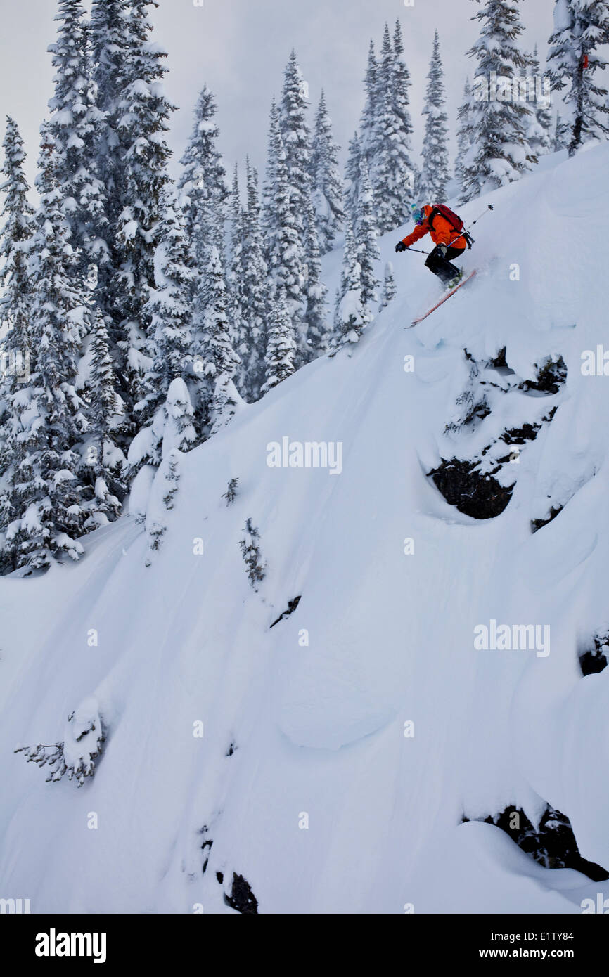 A male freeskier drops a cliff at Revelstoke Mtn Resort, BC Stock Photo