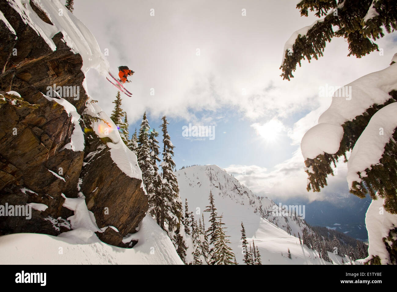 A male freeskier drops a cliff in the backcountry at Revelstoke Mtn Resort Backcountry, BC Stock Photo