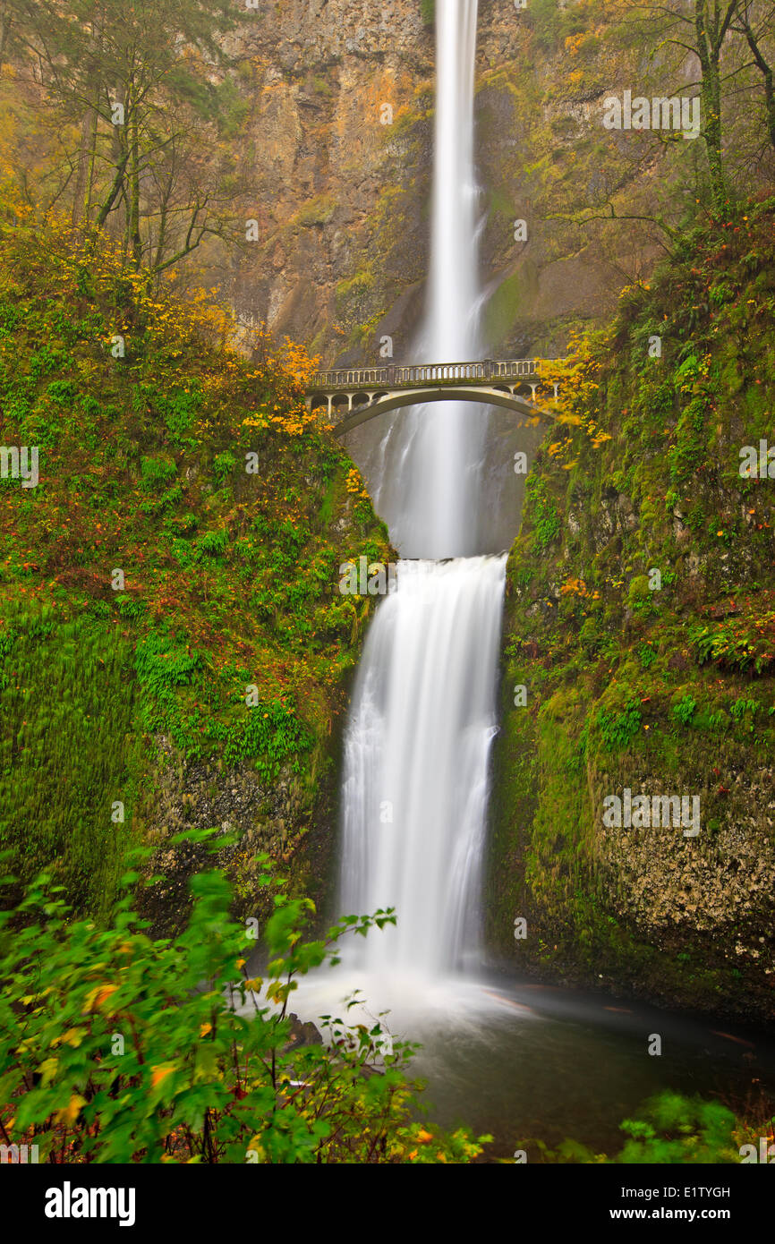 Tourist attraction Multnomah Falls a 611-foot-tall roaring awe-inspiring cascading waterfall in late fall with Benson Bridge Stock Photo
