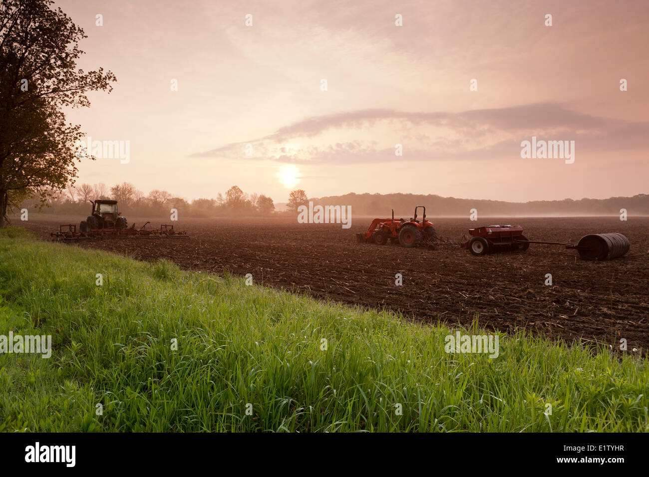 Farming equipment on a field at dawn in Prince Edward County, Ontario, Canada Stock Photo