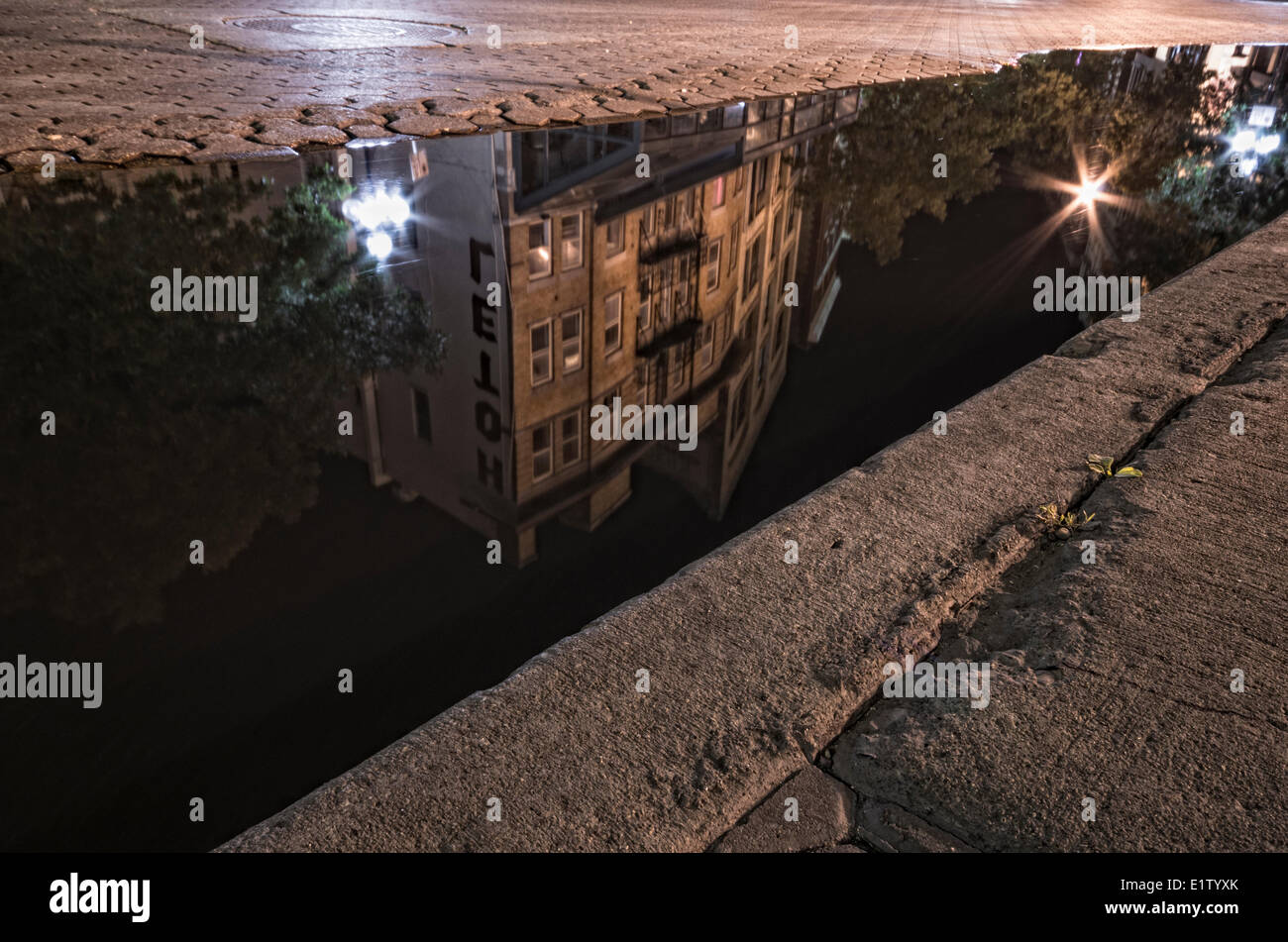 Reflection of an old heritage building in a puddle in Winnipeg's Exchange District. Manitoba. Stock Photo