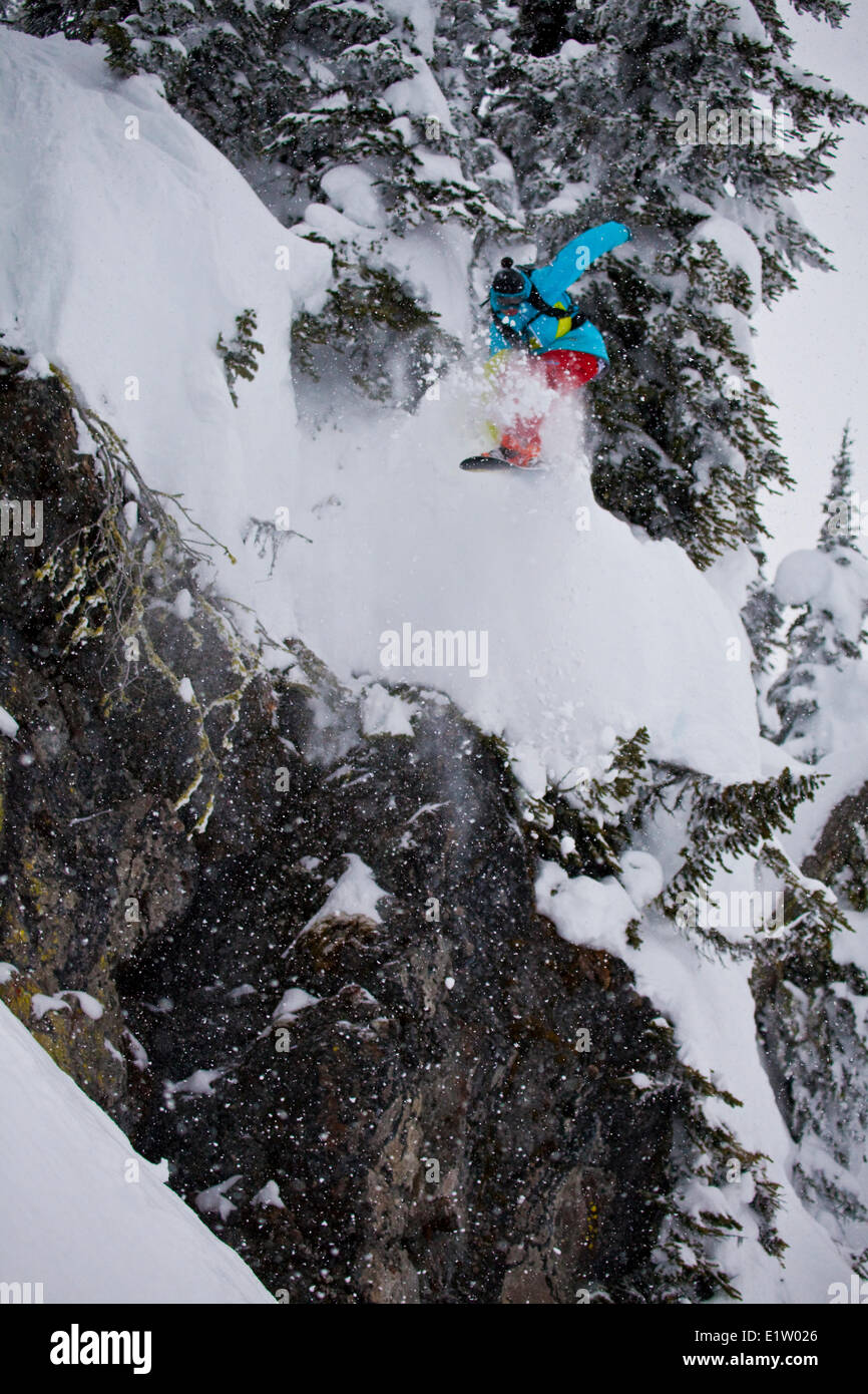 A young male snowboarder freeriding in the Revelstoke Mountain Resort Backcountry, BC Stock Photo