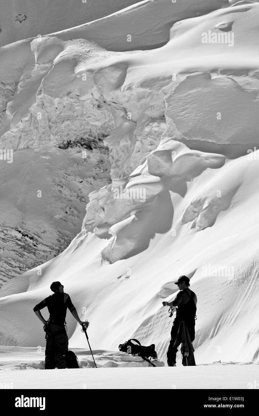 A backcountry skier and a splitboarder touring at Icefall Lodge, Canadian Rockies, Golden, BC Stock Photo