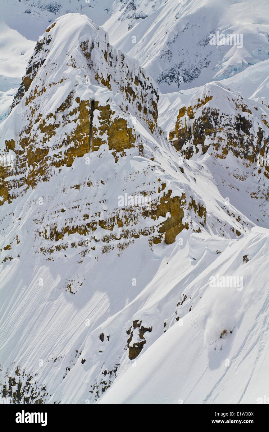 A male backcountry skiers rips a big line in the Candian Rockies