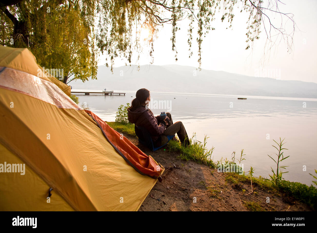 A young woman camping by Skaha Lake, Penticton, BC Stock Photo Alamy