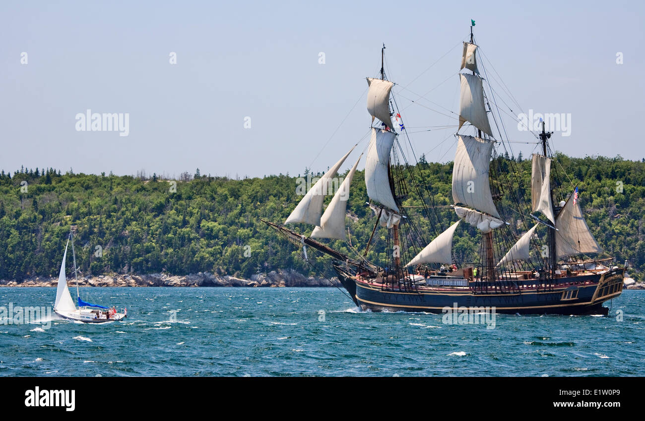 Sailing ship Bounty departs Halifax Harbour as a sailboat races alongside during the Parade Sail conclusion the 2012 Tall Ships Stock Photo