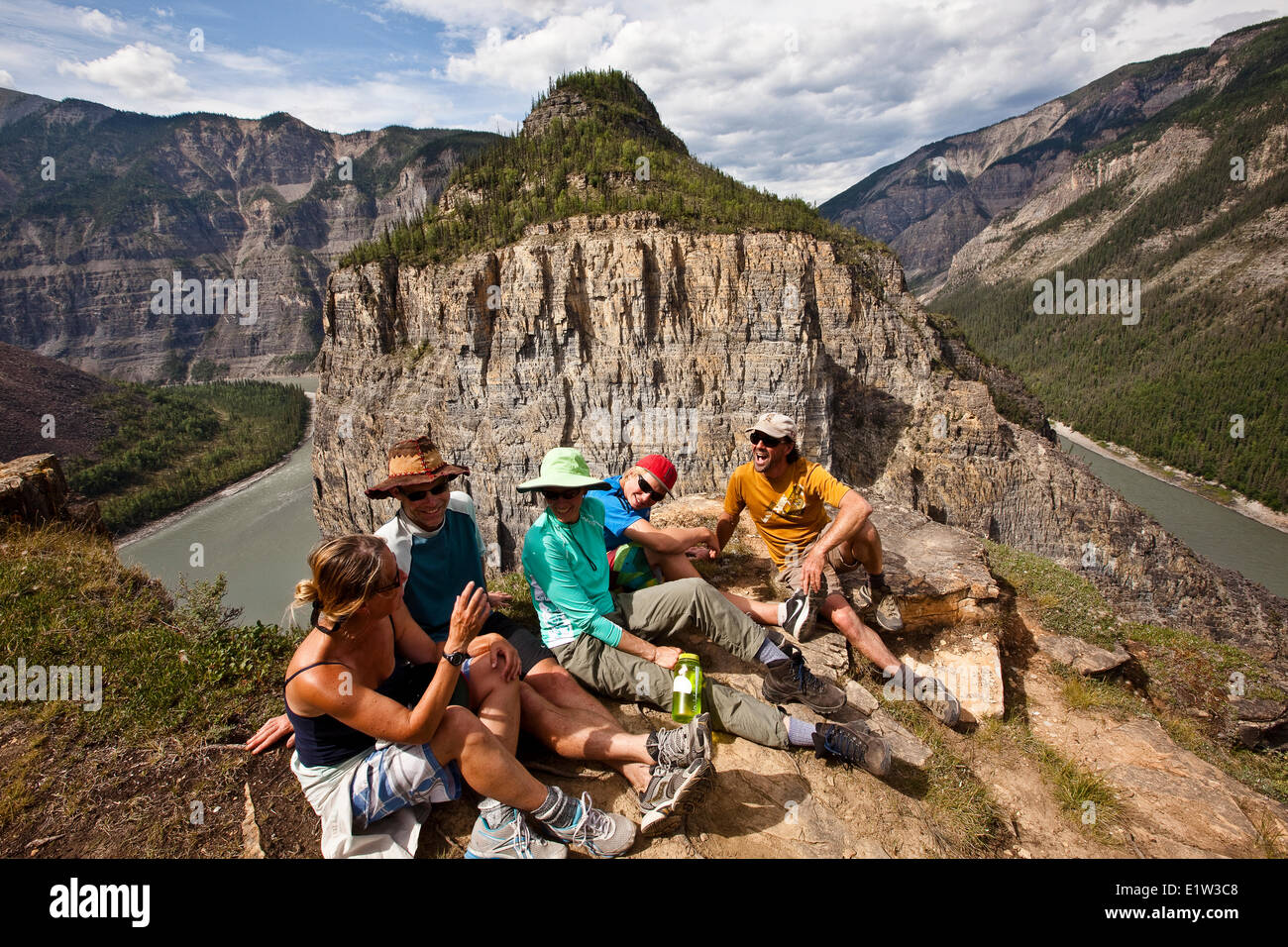 Several adults enjoy  view Nahanni River from cliff, Nahanni National Park Preserve, NWT, Canada. Stock Photo