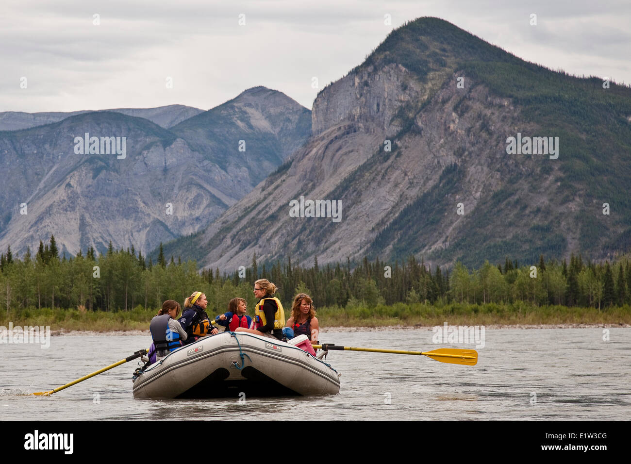 Group of women (mothers and daughters) on raft on Nahanni River, Nahanni National Park Preserve, NWT, Canada. Stock Photo