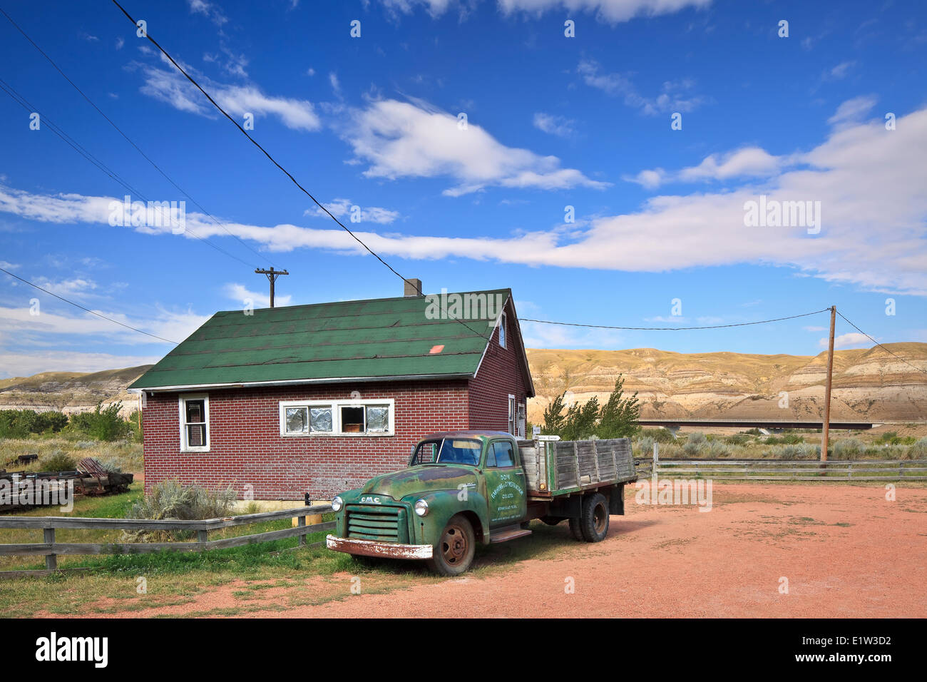 Old farm truck and home, Atlas Coal Mine National Historic Site, East Coulee, Alberta, Canada Stock Photo