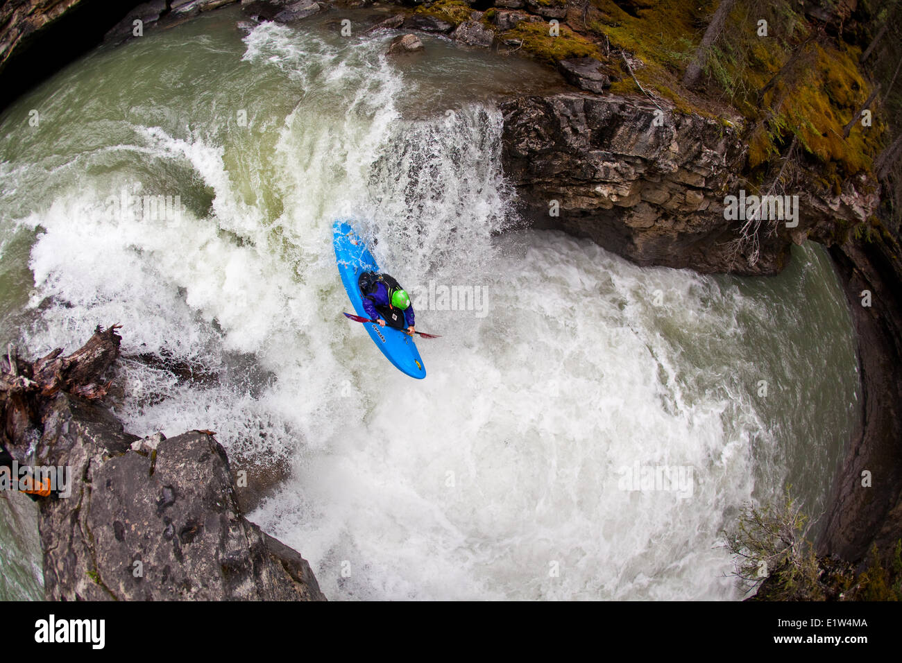 A male kayaker dropping a waterfall on Johnston Canyon, Banff National Park, AB Stock Photo