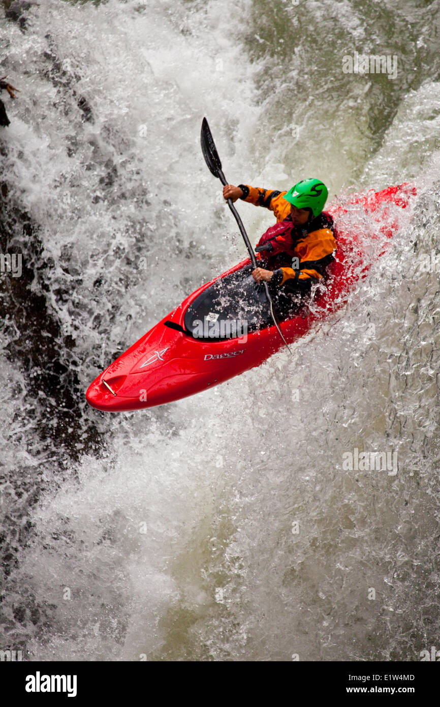 A male kayaker dropping a waterfall on Johnston Canyon, Banff National Park, AB Stock Photo