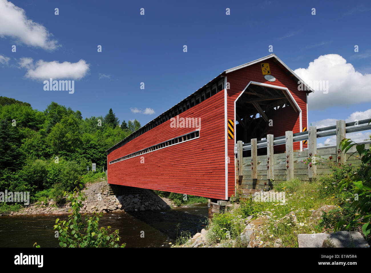 Red covered bridge (Pont LouisGravel) crossing the Rivière Sainte