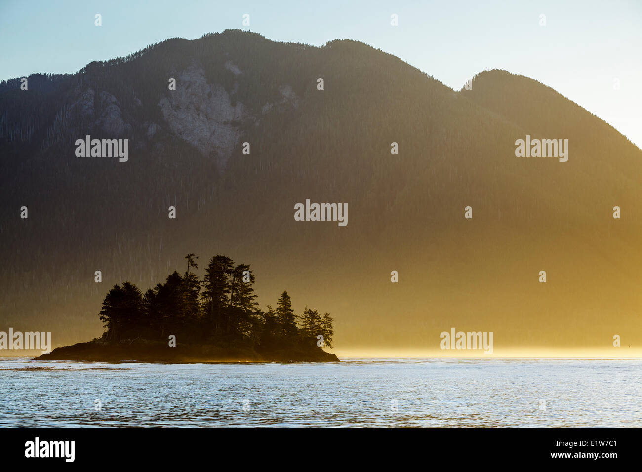 Part Whalers Islet at sunrise with the coastal mountains Vancouver Island in the background. Clayoquot Sound British Columbia Stock Photo