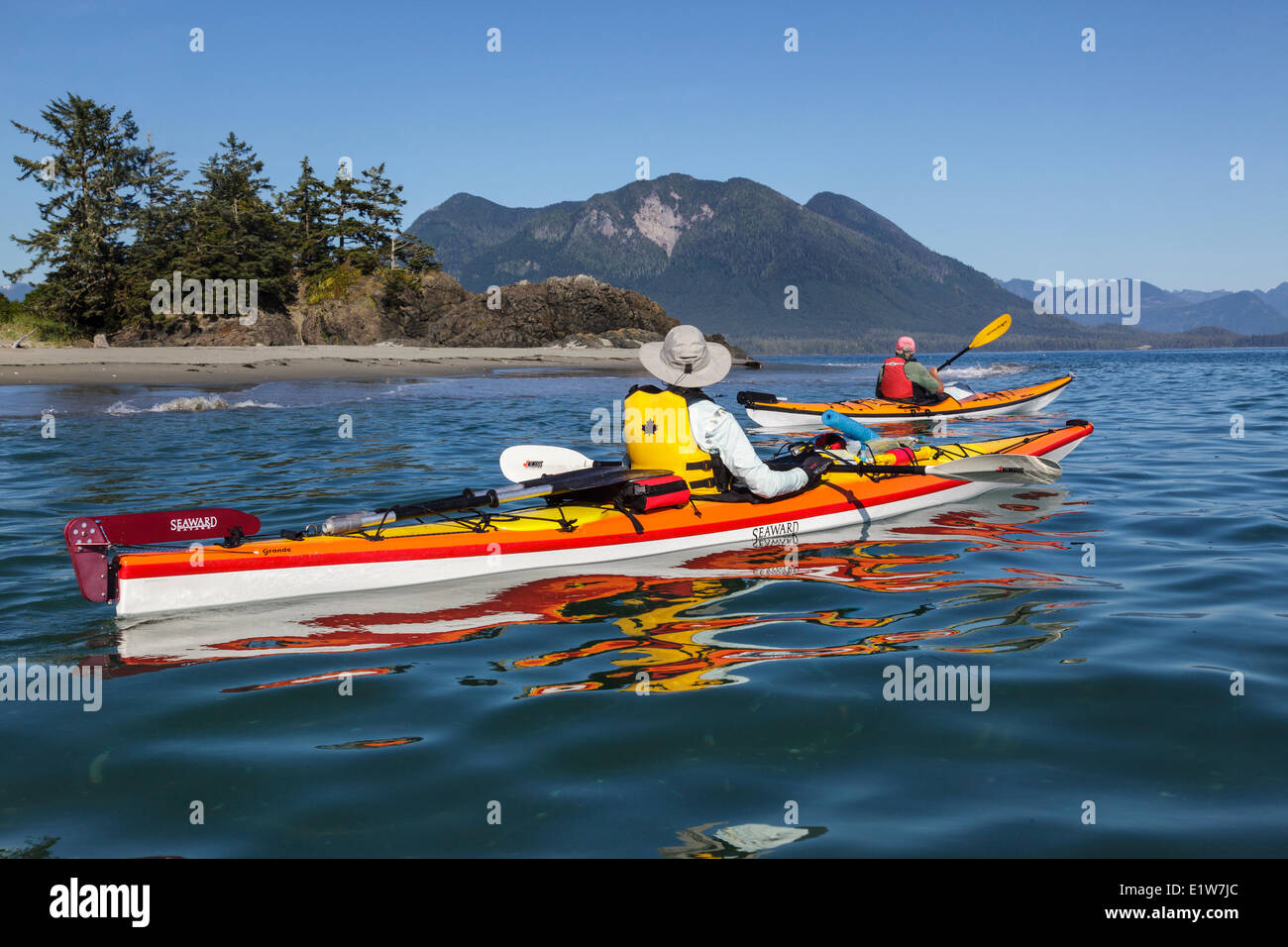 Two kayakers approach Whalers Islet in Clayoquot Sound off the west coast of Vancouver Island, British Columbia, Canada. Model R Stock Photo