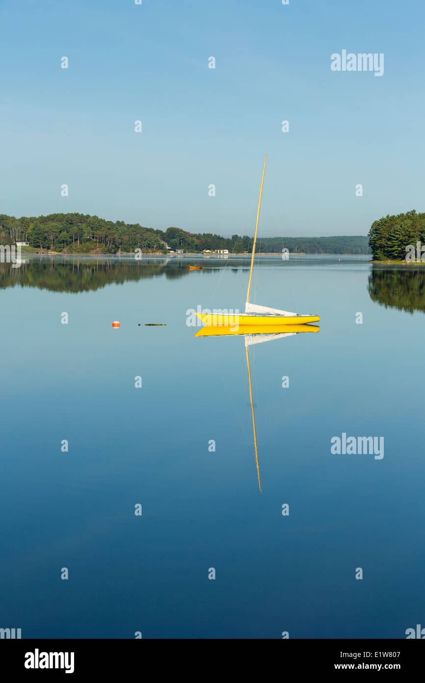 Sailboat reflected in LaHave River, Little Island, Nova Scotia, Canada