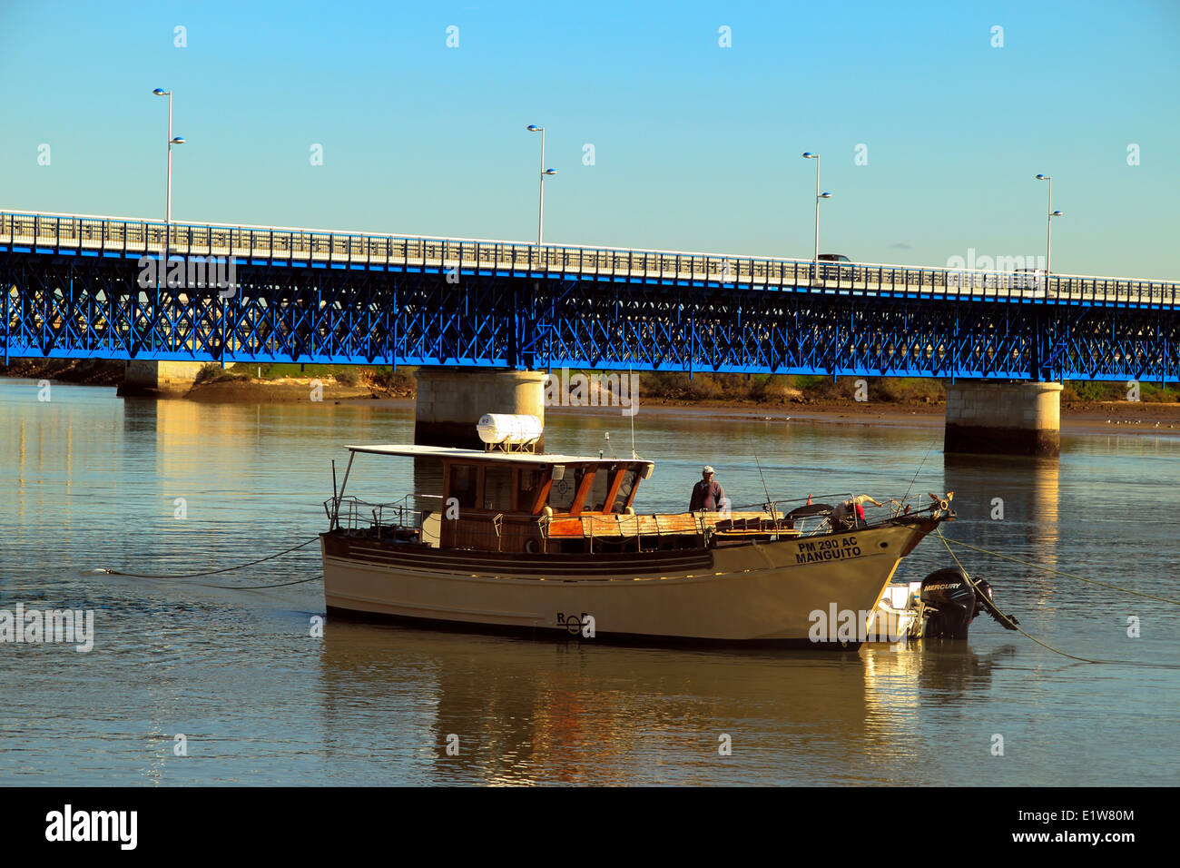 Road Bridge over the River Arade, with a boat in the foreground, Portimao Harbour, Algarve, Portugal Stock Photo