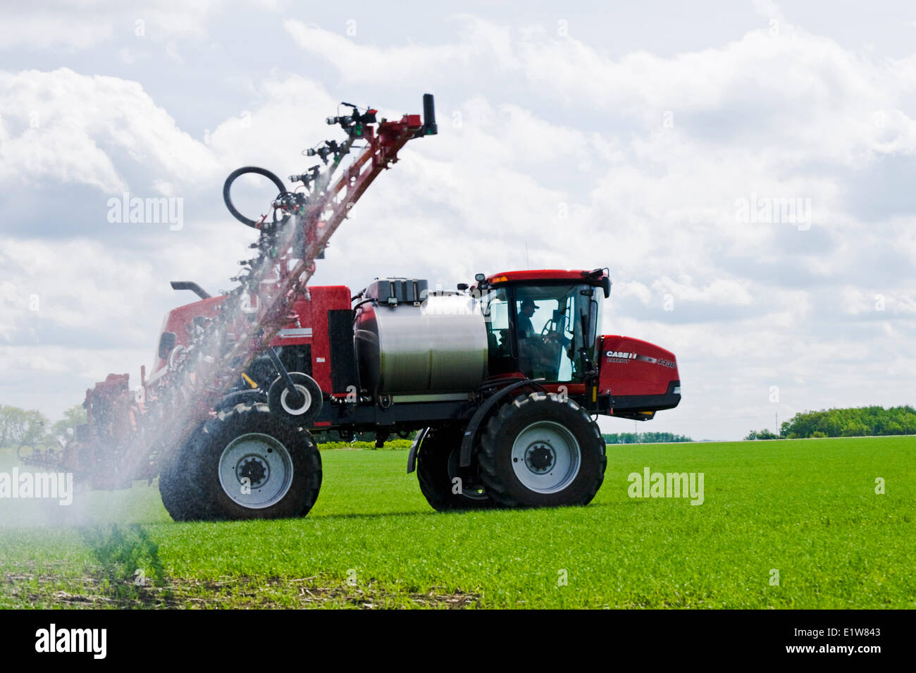A high clearance sprayer applies a chemical application of herbicide to